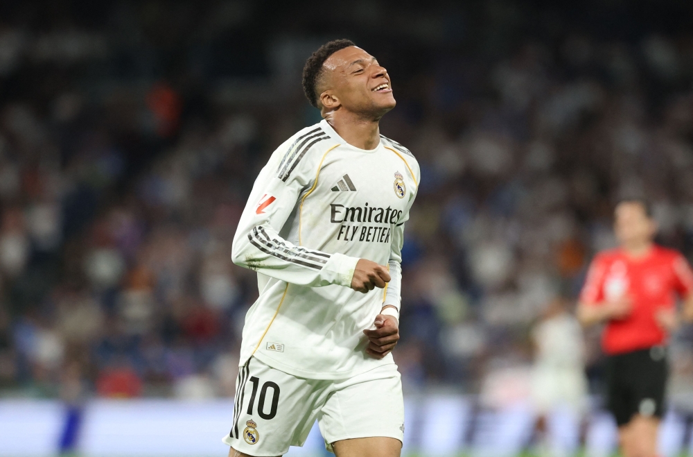Real Madrid's French forward #10 Kylian Mbappe reacts after missing a goal opportunity during the Spanish league 

