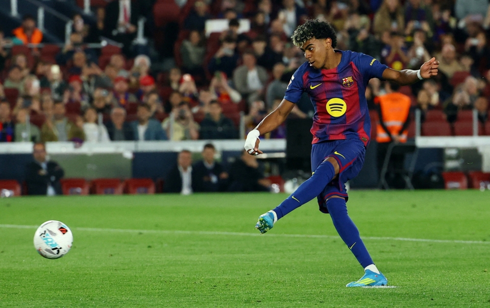   FC Barcelona's Lamine Yamal scores their first goal from the penalty spot  