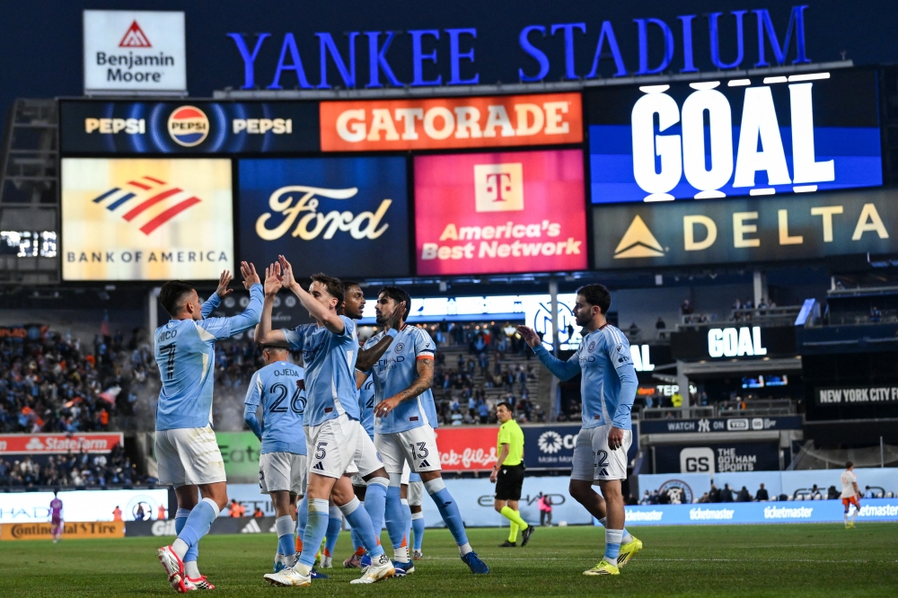 New York City FC defender Kai Trewin (5) celebrates the goal by New York City FC midfielder Nicol Fern dez (7) 