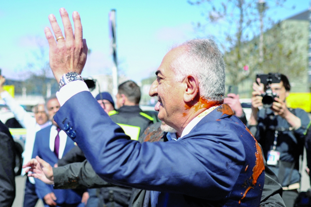 Reza Pahlavi splashed with sauce in Berlin on Thursday. — Reuters
