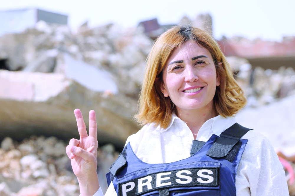A photograph shows Amal Khalil, a veteran correspondent for the daily newspaper Al Akhbar, in the southern Lebanese border village of Jebbayn in 2024. 