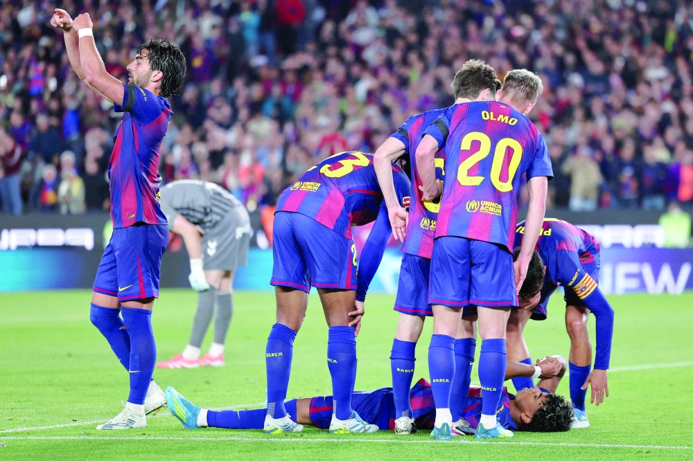 Barcelona's Spanish forward #07 Ferran Torres (L) asks for substitution as Barcelona's Spanish forward #10 Lamine Yamal lies on the ground after sustaining an injury during the Spanish league match against RC Celta de Vigo at Camp Nou stadium in Barcelona on April 22. — AFP
