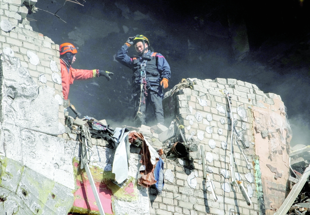 Rescuers work at the site of an apartment building hit by a Russian drone strike, amid Russia's attack on Ukraine, in Dnipro, Ukraine, on Thursday. — Reuters