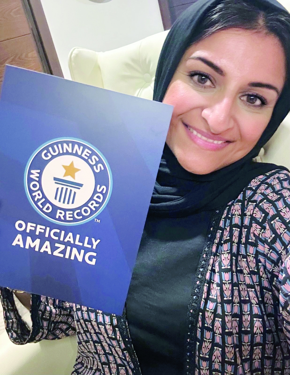 Ruby Saharan holding her Guinness World Record Certificate