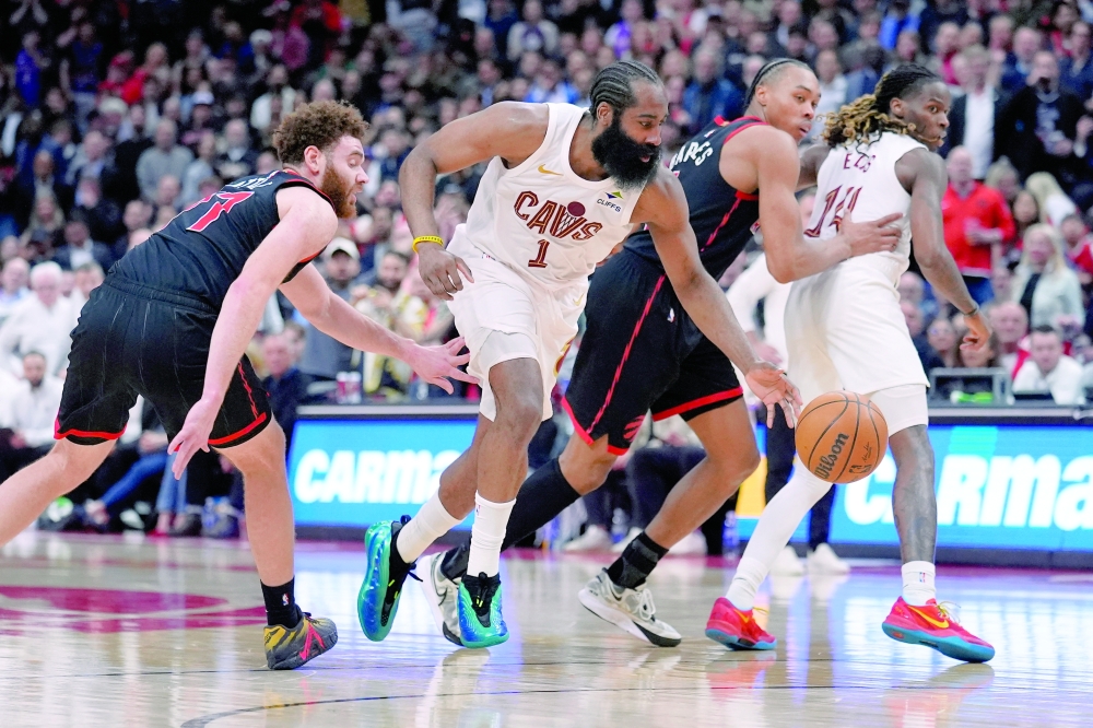 Cleveland Cavaliers' James Harden (1) drives to the basket against Toronto Raptors' Jamison Battle (77) and Scottie Barnes (4) in game three of the first round of the 2026 NBA Playoffs at Scotiabank Arena. — Imagn Images