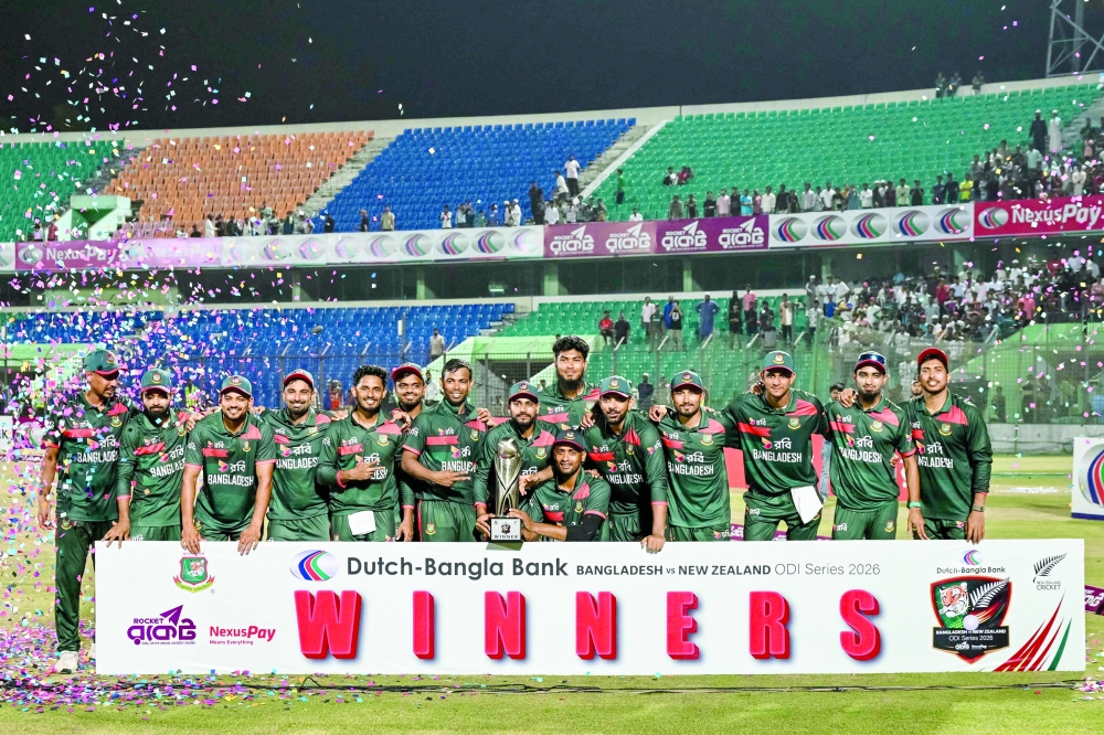Bangladesh's players pose with the trophy for a group photo after winning the series at the end of the third one-day international (ODI) cricket match between Bangladesh and New Zealand at the Bir Sreshtho Flight Lieutenant Matiur Rahman Stadium in Chittagong on April 23, 2026.  (Photo by Munir UZ ZAMAN / AFP)
