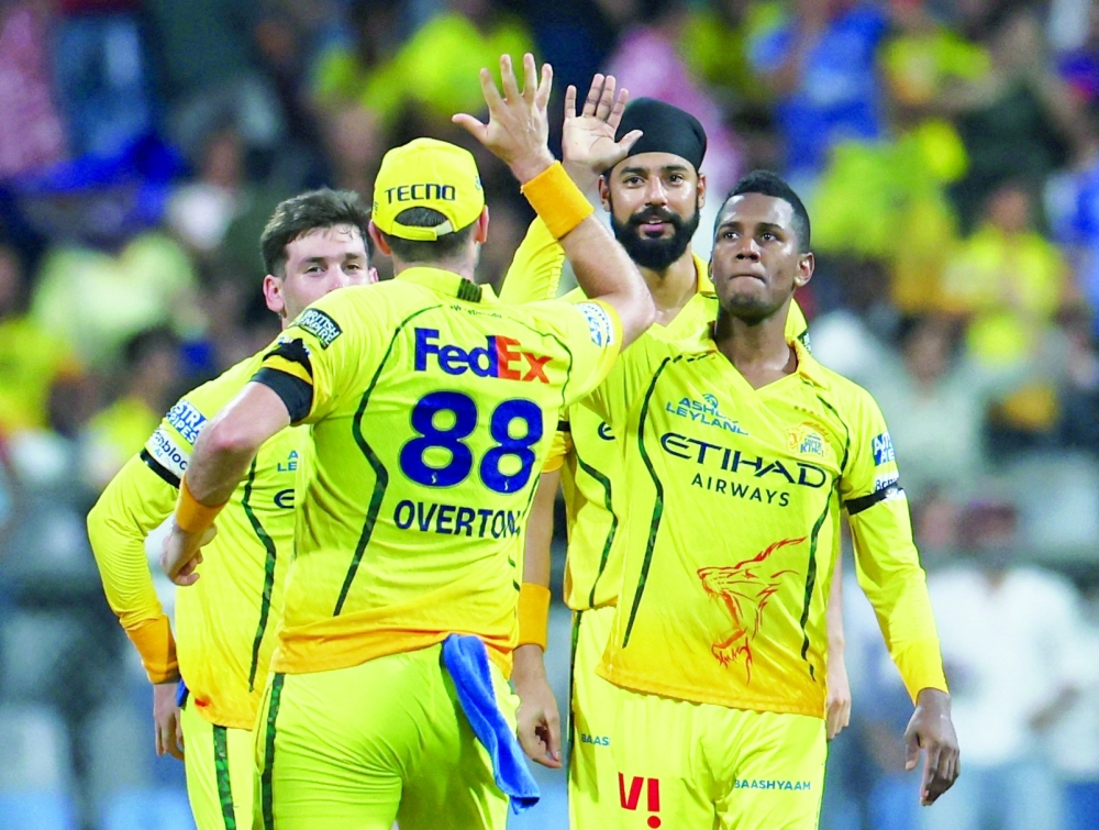 Chennai Super Kings' Akeal Hosein celebrates with teammates after taking the wicket of Mumbai Indians' Suryakumar Yadav. — Reuters