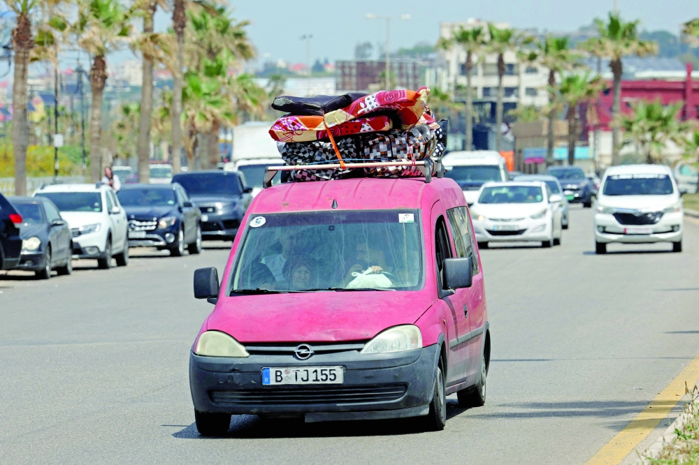 A car loaded with personal belongings drives through the coastal southern city of Sidon as displaced residents return home after an extension of the ceasefire. — AFP
