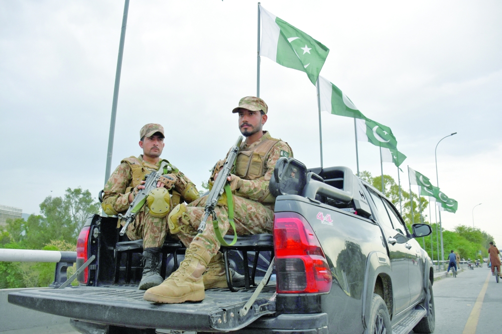 Army soldiers patrol a road as Pakistan prepares to host US and Iran for the second round of peace talks in Islamabad on Friday. — Reuters