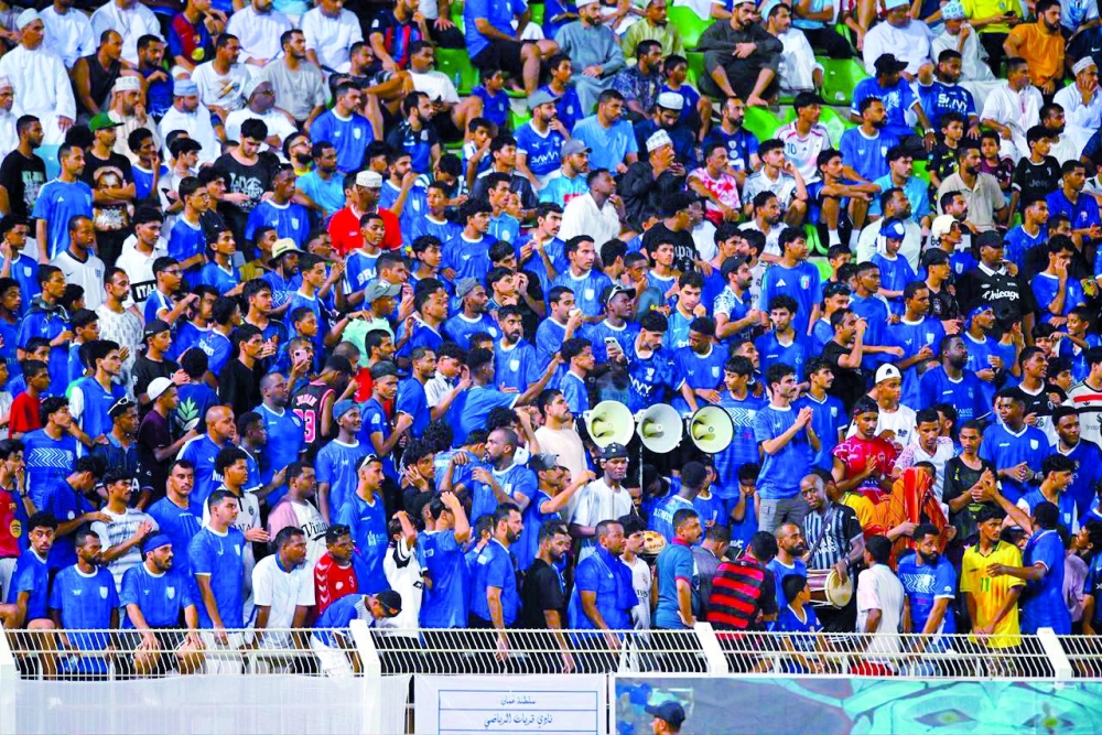 Spectators cheer during an amateur football competition.
