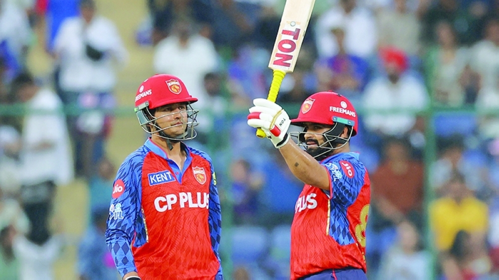 Punjab Kings' Prabhsimran Singh celebrates with Priyansh Arya after reaching his half century in New Delhi. — Reuters