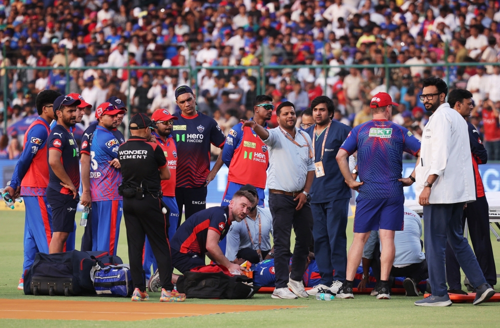   Delhi Capitals' Lungi Ngidi receives medical attention after sustaining an injury  