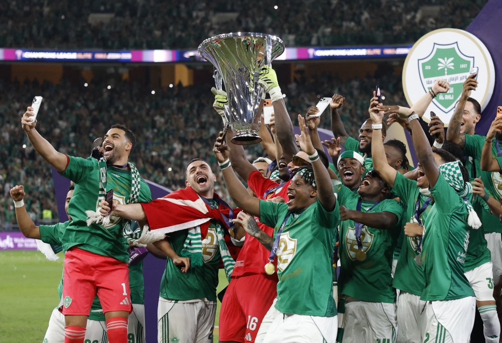   Al Ahli's Edouard Mendy celebrates with the trophy and teammates after winning the Asian Champions League  