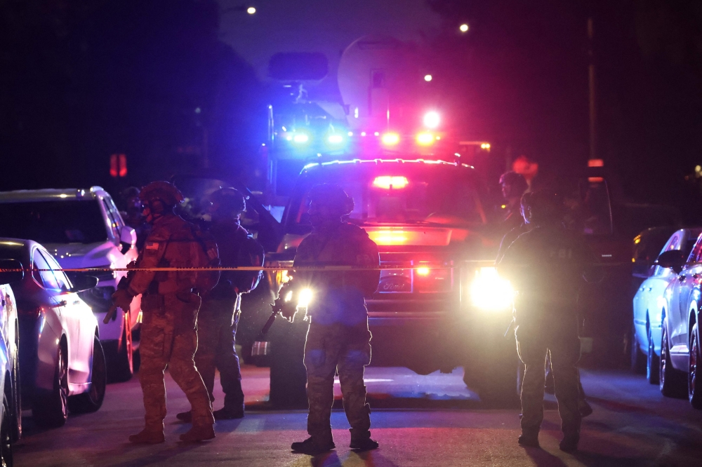 An FBI tactical team arrives in armored vehicles outside a house associated with the suspected White House Correspondents’ Dinner shooter as in Torrance, California, on April 25, 2026. 
