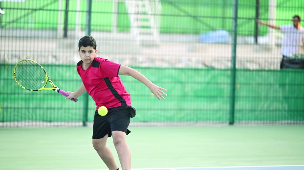 A young player returns the ball during last year’s junior tennis tournament in Muscat.

