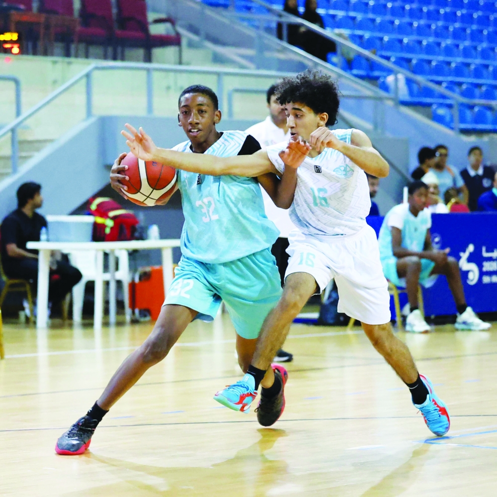 Players battle for possession during a closely contested match in the Athletes Preparation Centres Basketball League. — Omar al Musafir