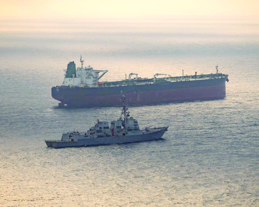 USS Rafael Peralta (DDG 115) near what the US Central Command said was a vessel attempting to sail to an Iranian port, as it enforces the US blockade on Iranian ports. — Reuters