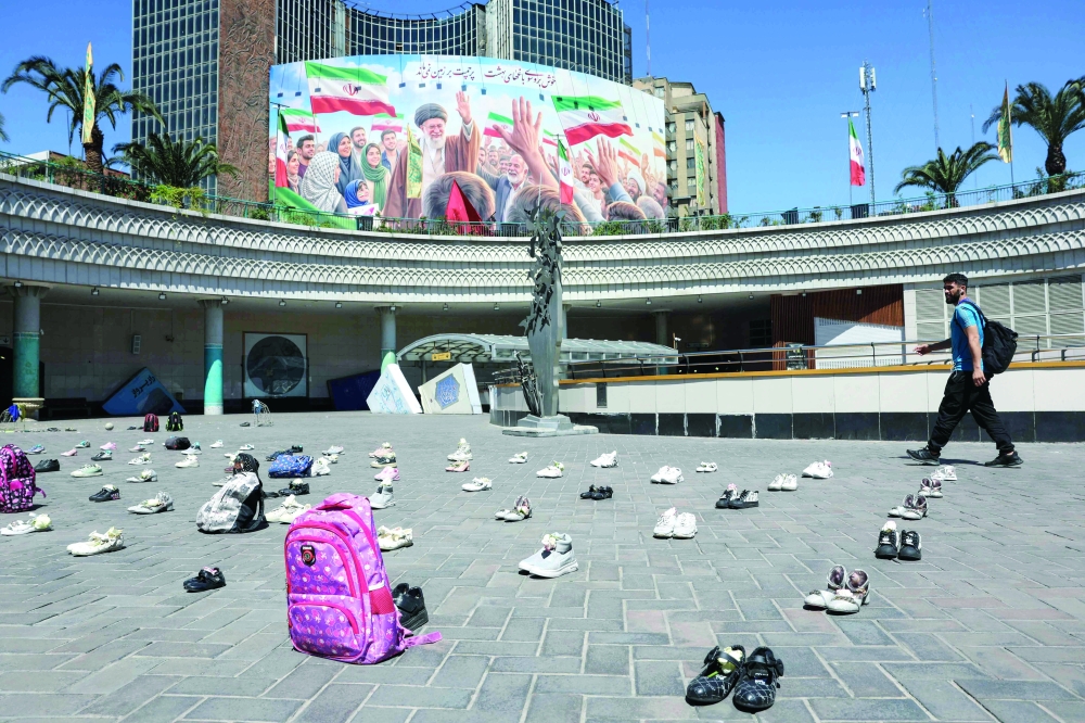 
Symbolic belongings laid on the ground at Valiasr Square in Tehran in tribute to the Minab schoolgirls. — AFP 