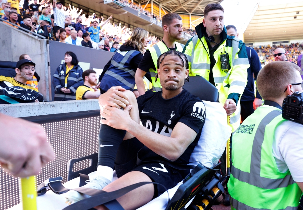 Tottenham Hotspur's Xavi Simons is carried off the pitch in a stretcher after sustaining an injury 