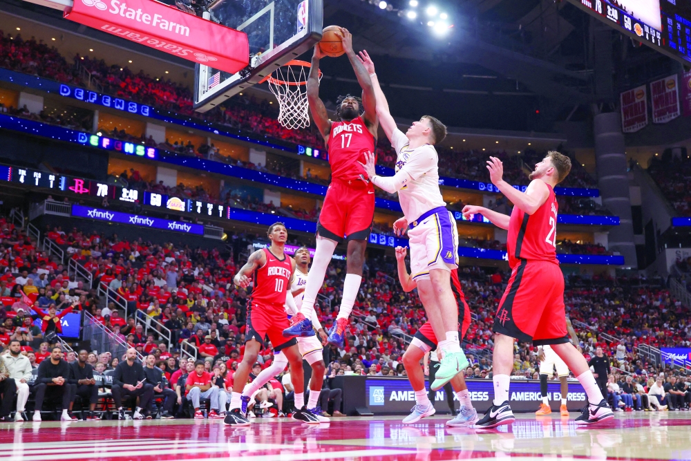 Houston Rockets forward Tari Eason  gets a rebound away from Los Angeles Lakers forward Jake LaRavia. — Imagn Images