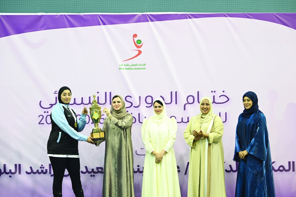 The patron presents the championship trophy to Masirah following their victory in the league final.  — Abdulwahid al Hamadani