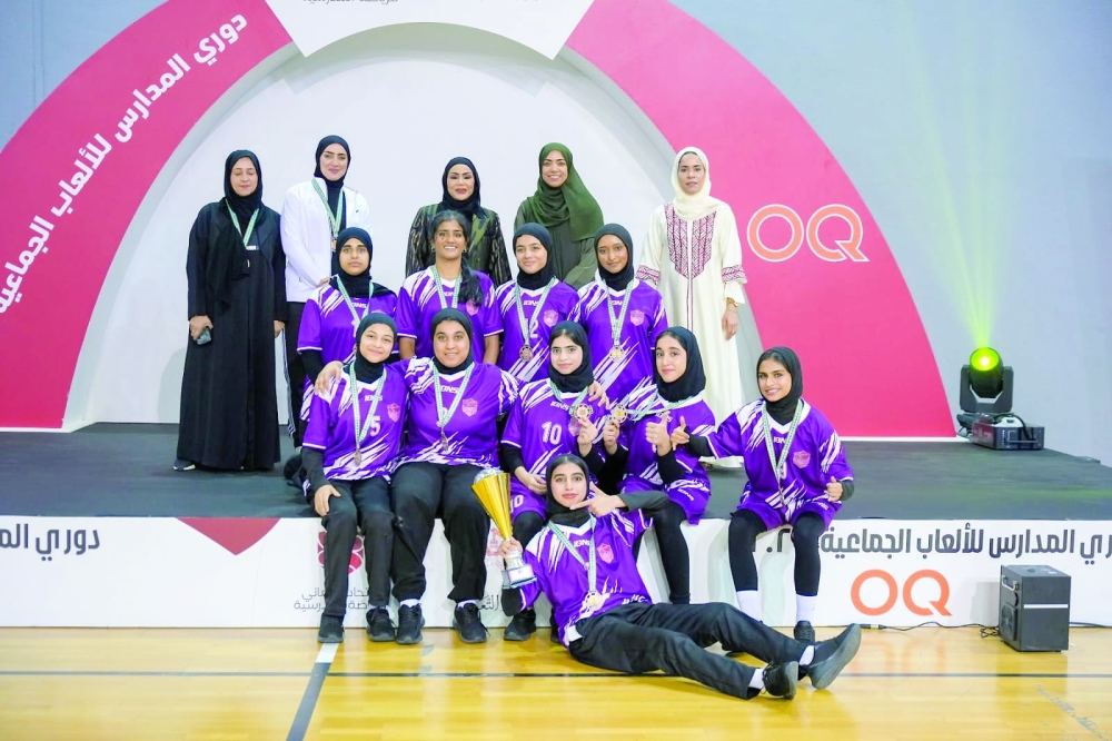 One of the medal winning team pose with their trophy.