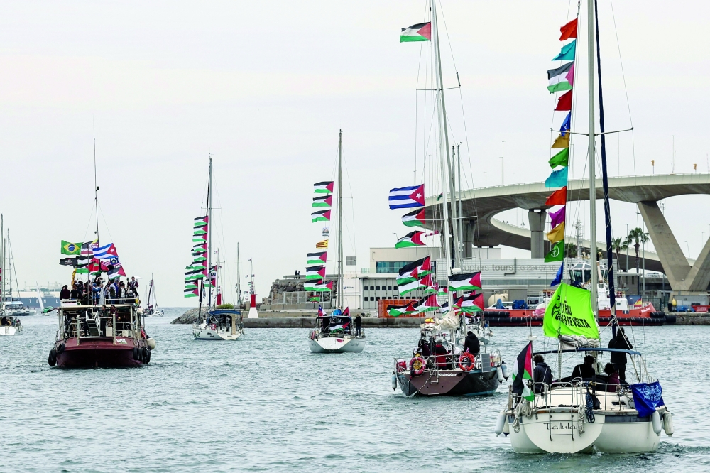 Boats of a new humanitarian flotilla bound for the Gaza Strip make a symbolic leave from Barcelona's Port Vell. — AFP File