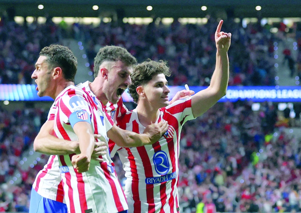 Atletico Madrid's Julian Alvarez celebrates scoring their first goal with Koke and Matteo Ruggeri. REUTERS