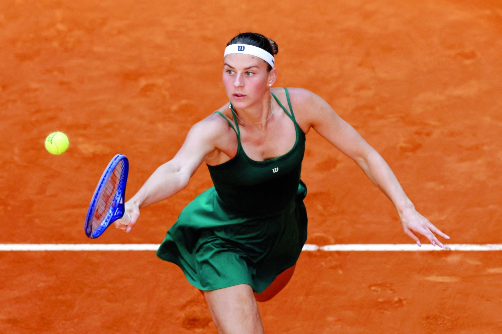 Ukraine's Marta Kostyuk returns the ball to US Jessica Pegula during their 2026 WTA Tour Madrid Open tennis tournament third round singles match at the Caja Magica in Madrid, on April 26, 2026.  (Photo by OSCAR DEL POZO / AFP)
