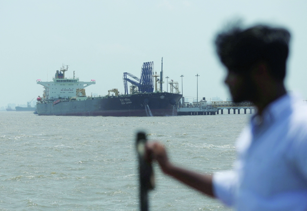 A man looks at the India-flagged tanker Desh Garima, as it unloads crude oil at an offloading terminal after transiting the Strait of Hormuz, in Mumbai. — Reuters