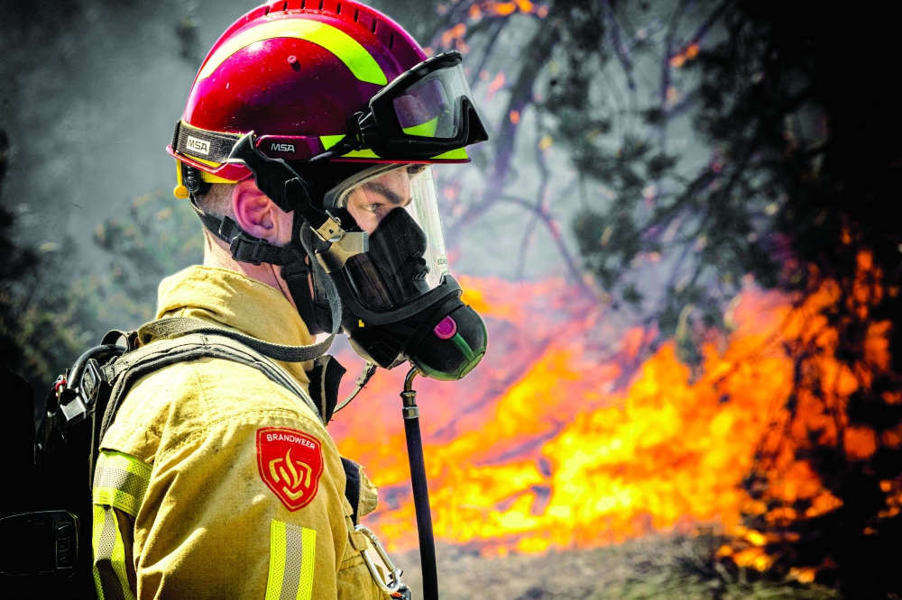 A firefighter works to extinguish a wildfire near Budel, on May 1, 2026 a day after it broke out at a military training ground where a military exercise was taking place. — AFP