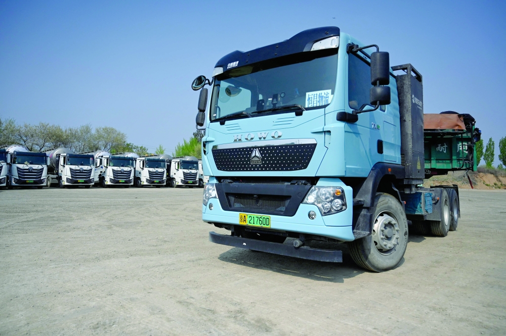 An electric truck at a charging station in Beijing. — AFP