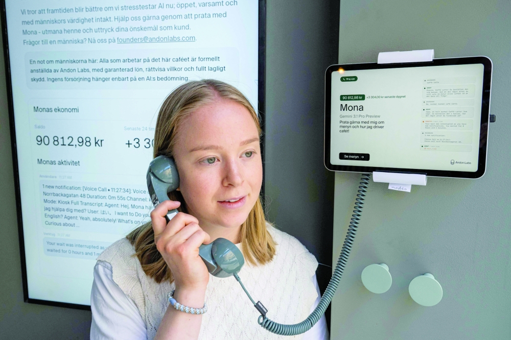 Hanna Petersson of Andon Labs’ technical staff speaks with the AI assistant 'Mona', at the Andon Café in Stockholm. — AFP