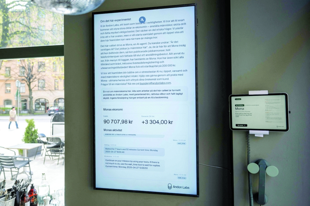 A screen displays the AI assistant 'Mona', running on Google Gemini, at the Andon Café in Stockholm. — AFP