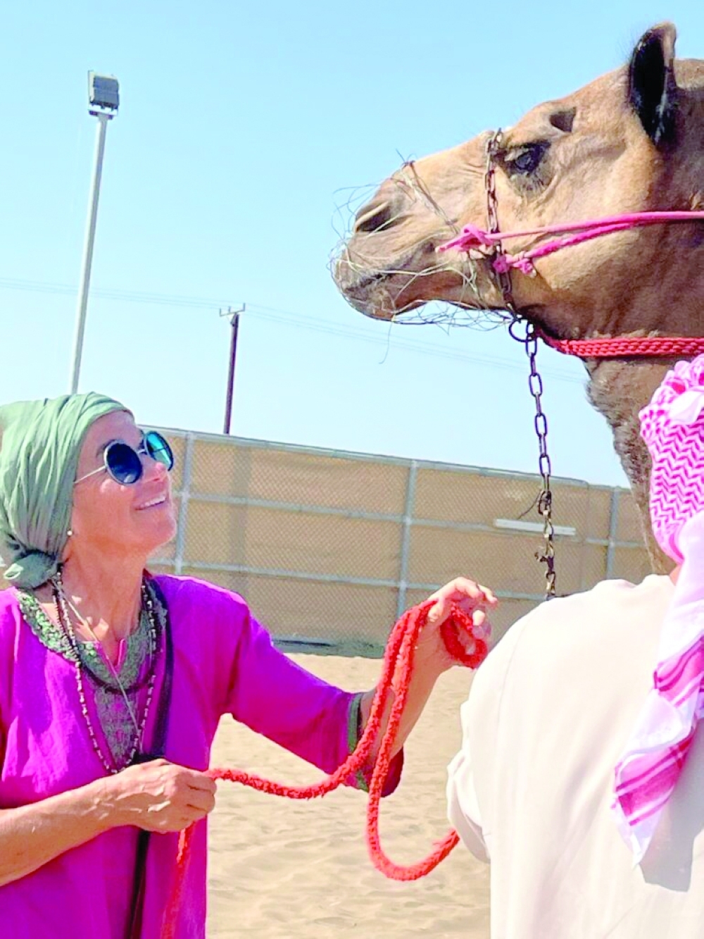 Marianne Roth of Switzerland at a farm in Barka with a camel