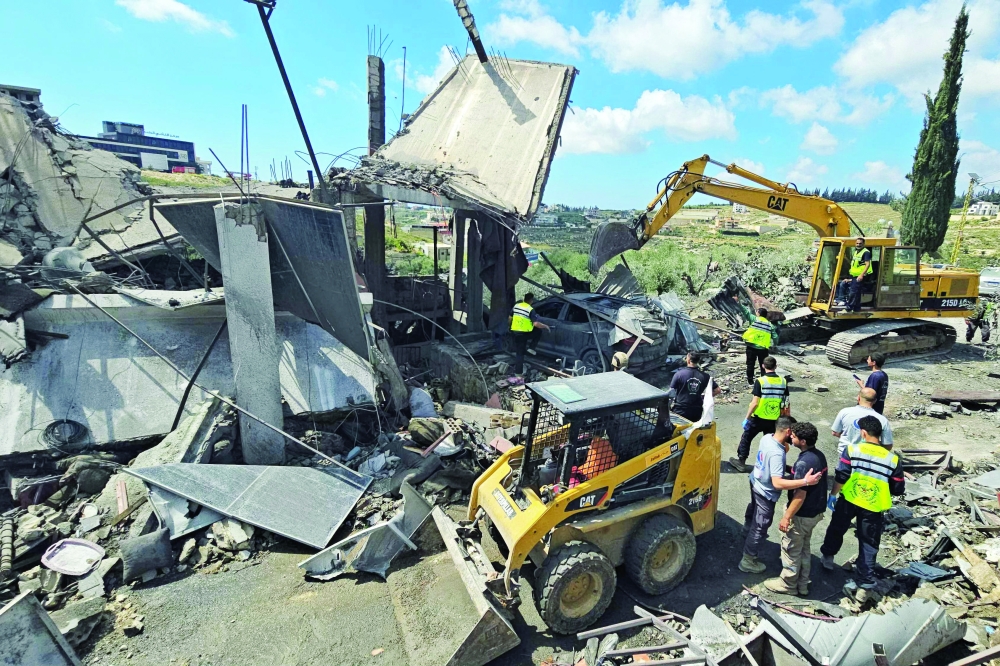 First responders search for survivors among the rubble at the site of an Israeli air strike that targeted the southern Lebanese village of Ain Baal.
Israeli air strikes on southern Lebanon killed at least 17 people, the Health Ministry announced. — AFP