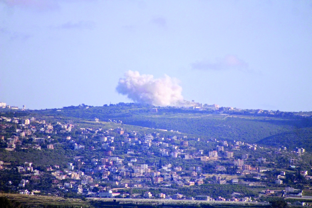 The southern Lebanese area of Tyre shows smoke rising from an Israeli controlled explosion in the village of Chamaa. — AFP