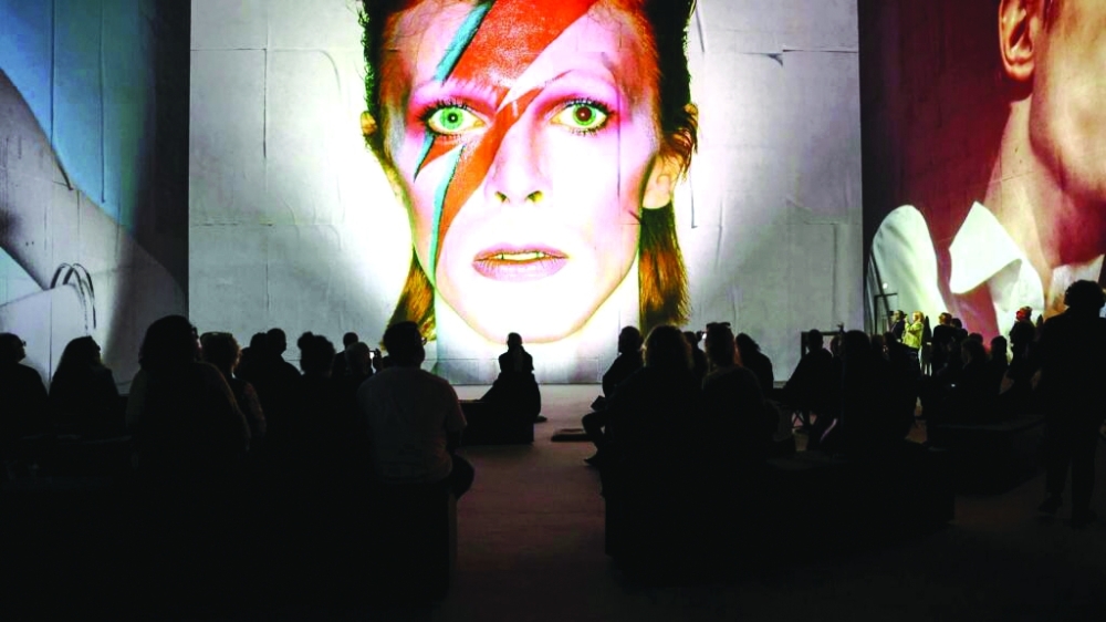 People attend the multimedia show 'David Bowie: You're Not Alone', showcasing work from the British musical legend, at the Lightroom venue in Kings Cross in London. — AFP