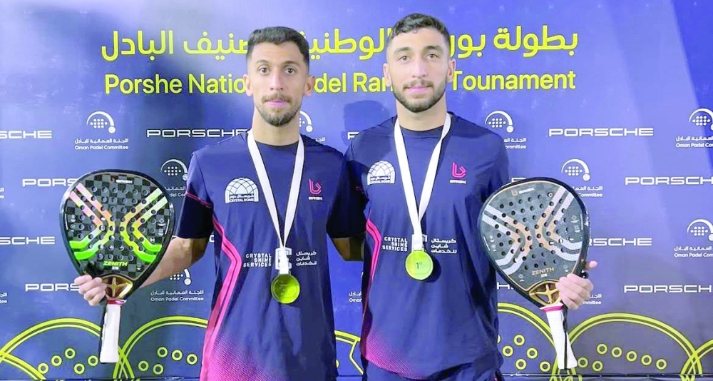 Younis and Muneer al Rawahi with the title after winning a tournament.