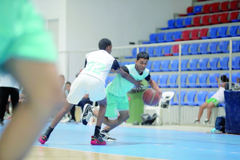 Nizwa and Al Amerat players battle for possession during their Athletes’ Development Centres Basketball League match in Muscat. — Ammar al Musafir