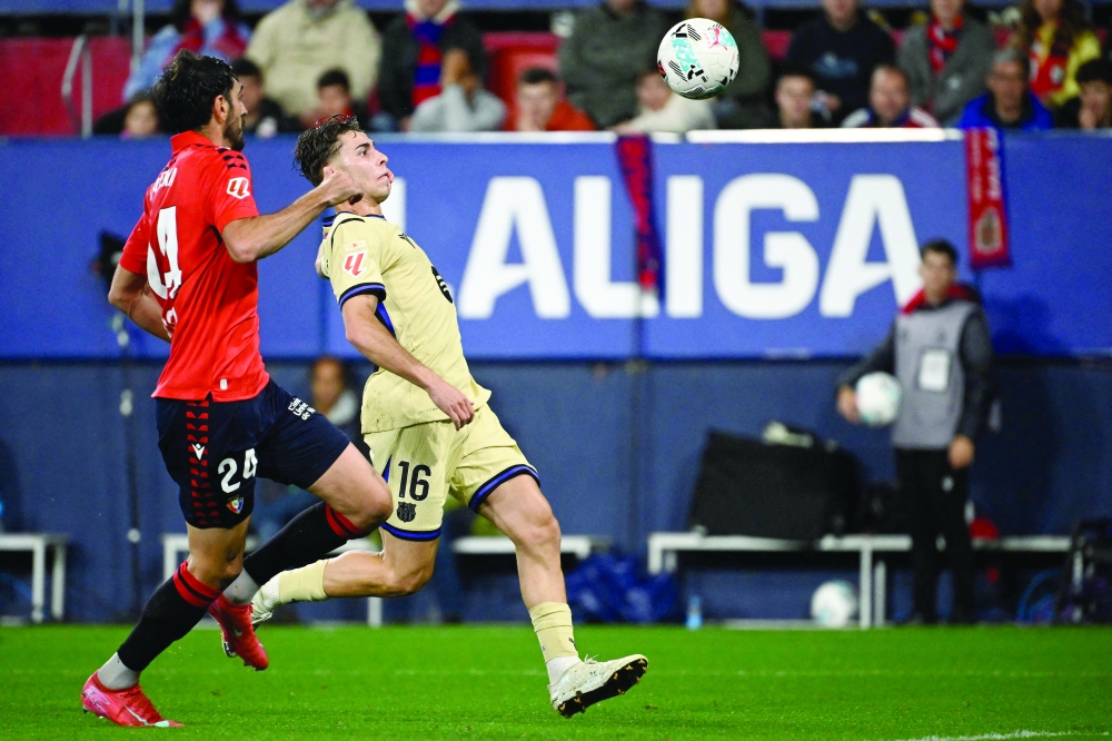 Alejandro Catena and Barcelona's Spanish midfielder Fermin Lopez vie for the ball during the Spanish league football match between CA Osasuna and FC Barcelona. — AFP