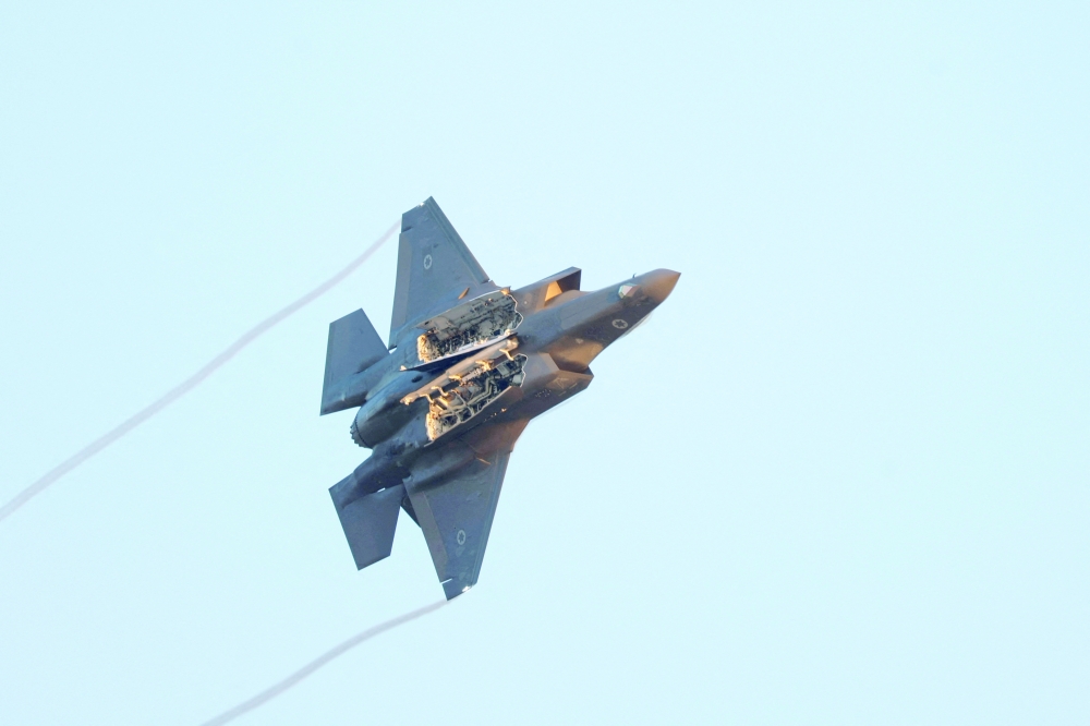 A F-35 fighter jet flies with weapon bay doors open at Hatzerim Airbase, in southern Israel. — Reuters 