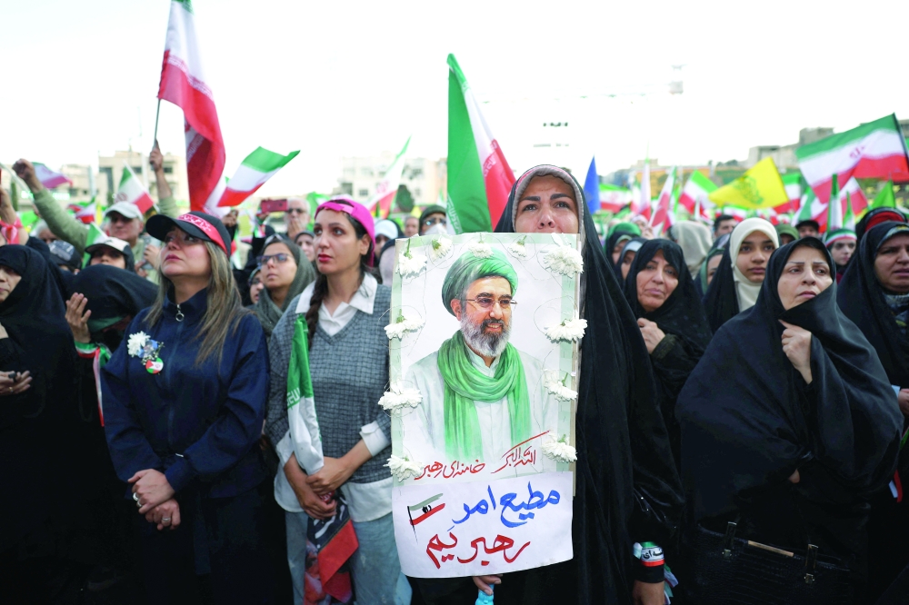A woman holds a poster depicting Iran’s new Supreme Leader, Mojtaba Khamenei, during a rally in Tehran. — Reuters 