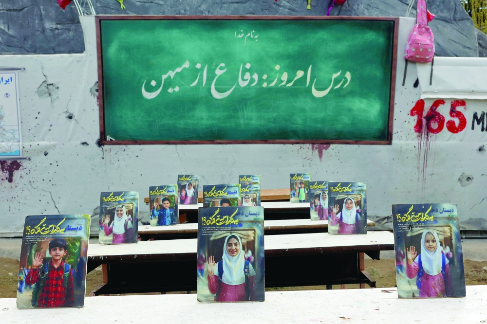 A memorial depicting a symbolic classroom representing the Minab school children is displayed in a square in Tehran. — AFP