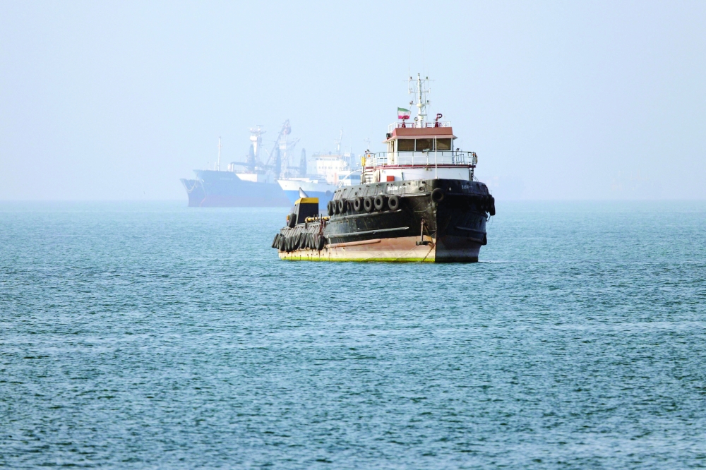 In this picture obtained from Iran's ISNA news agency on Monday, the Iran-flagged tugboat Basim sails near a ship anchored in the Strait of Hormuz off Bandar Abbas in southern Iran. - AFP