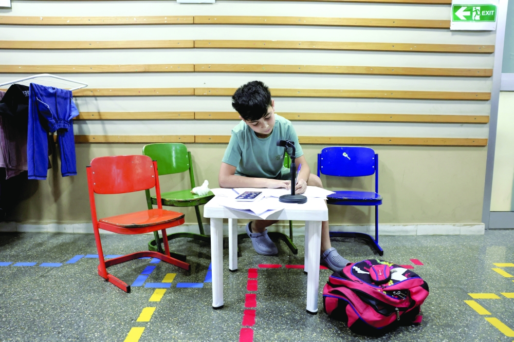 A displaced child from southern Lebanon attends an online class in Hariri High School II, in Beirut. — Reuters 