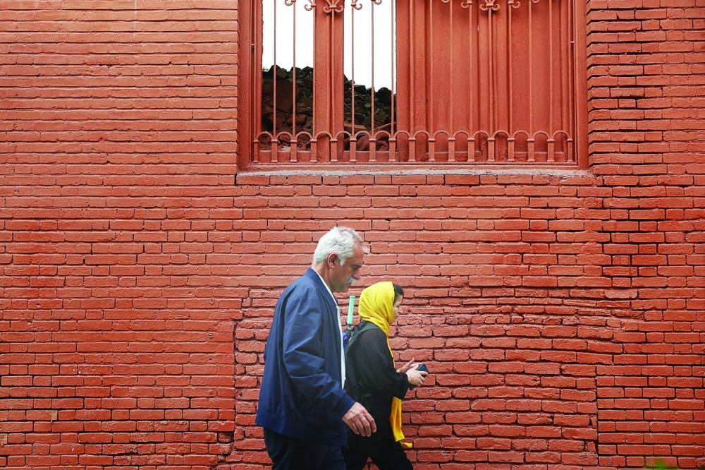 People walk on a street in Tehran, Iran. — Reuters 