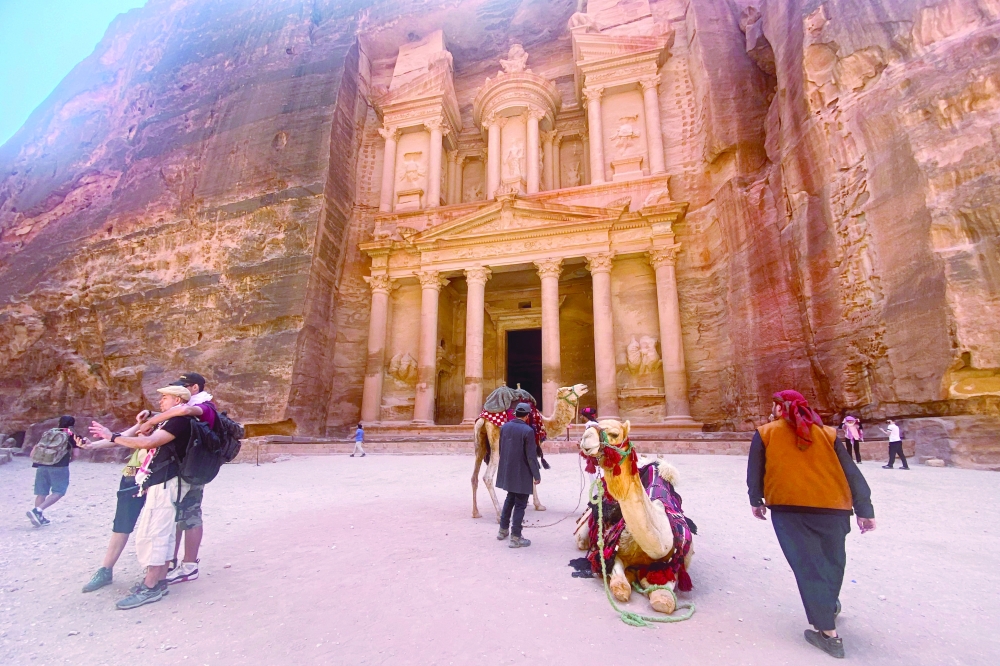Tourists visit the Treasury in the ruins of the ancient Nabatean city of Petra, in southern Jordan. — AFP