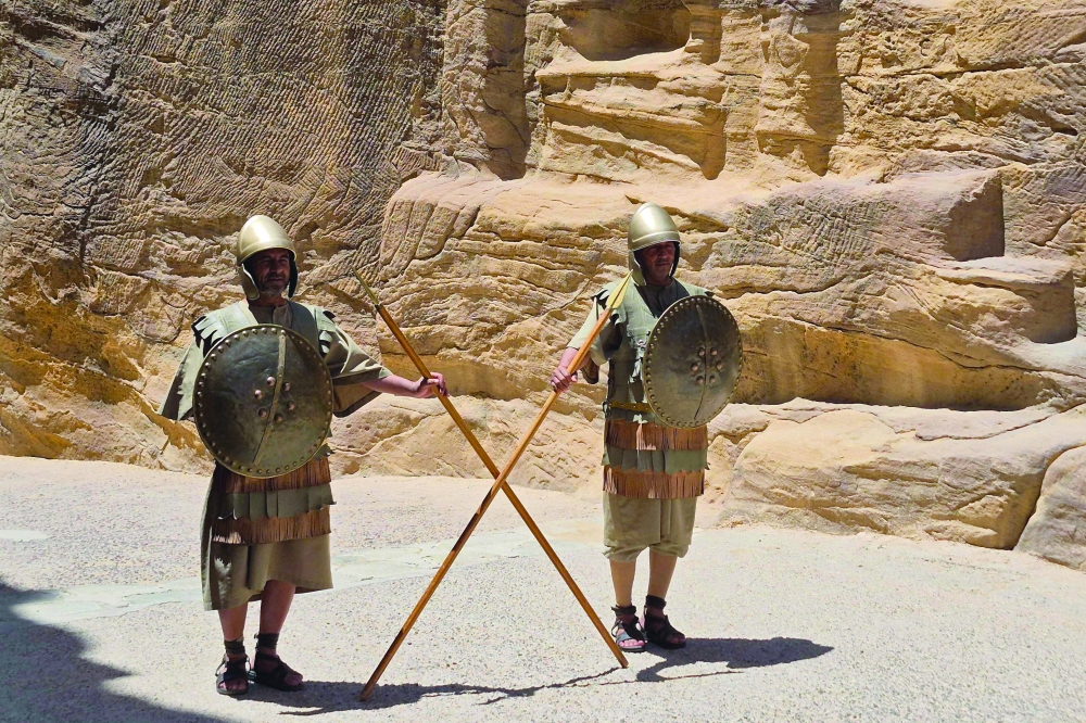 Traditionally dressed Nabatean Guards in their uniform hold spears at the Siq of Petra. — AFP