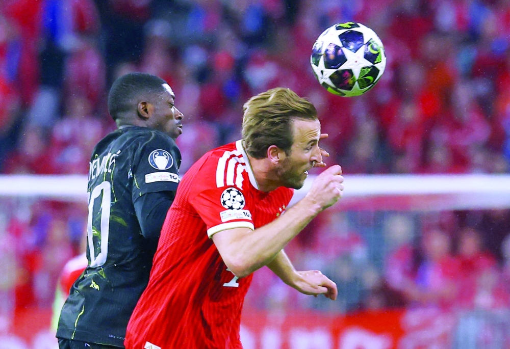 Paris St Germain's Ousmane Dembele in action with Bayern Munich's Harry Kane REUTERS